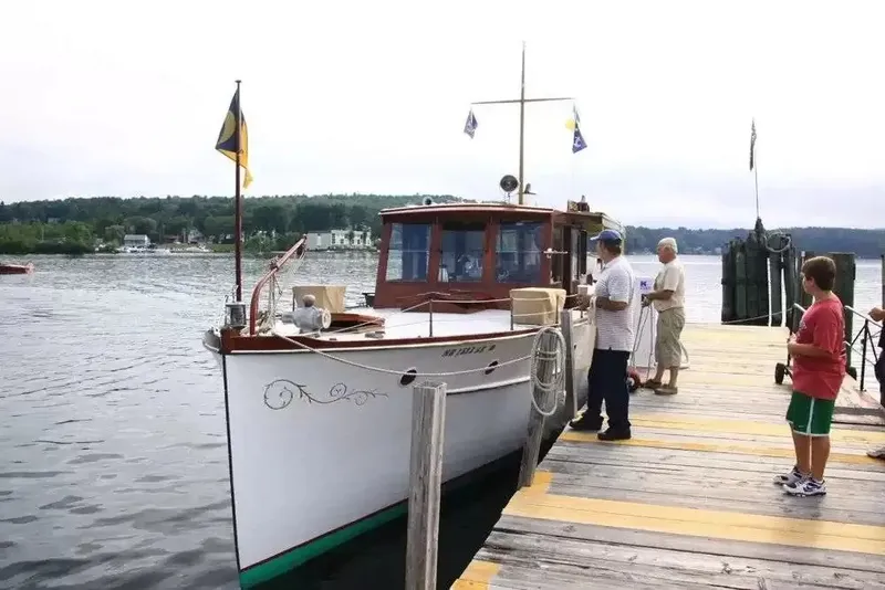 Slide: The Image of A classic 1926 Hubert Johnson 43' Flat Top Cruiser docked at a wooden pier. - 4