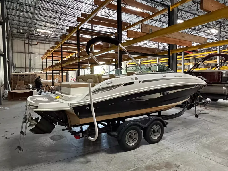 Slide: The Image of A 2011 Sea Ray 220 Sundeck on a trailer inside a warehouse. - 3