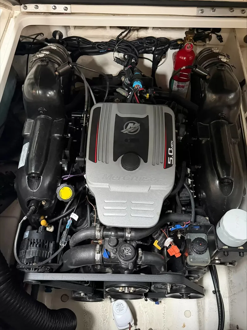 Slide: The Image of The engine compartment of a 2011 Sea Ray 220 Sundeck features a MerCruiser 5.0L V8 engine. - 12