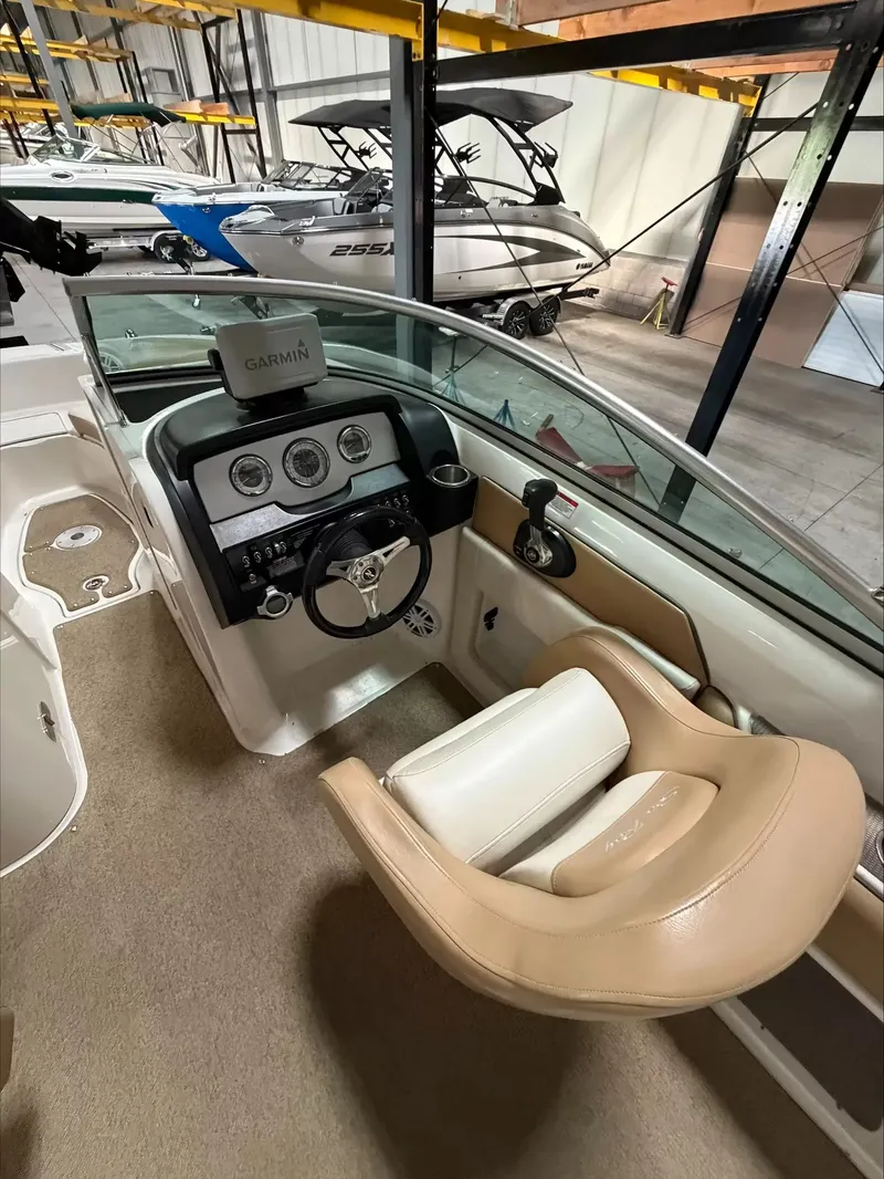 Slide: The Image of The image shows the cockpit of a 2011 Sea Ray 220 Sundeck with a Garmin navigation system. - 7