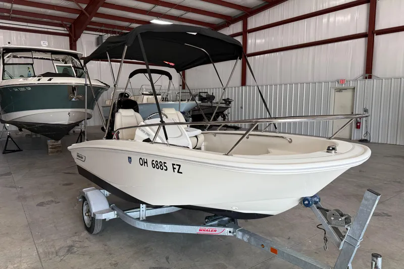 Slide: The Image of 2021 Boston Whaler 130 Super Sport boat on trailer in indoor storage facility. - 4