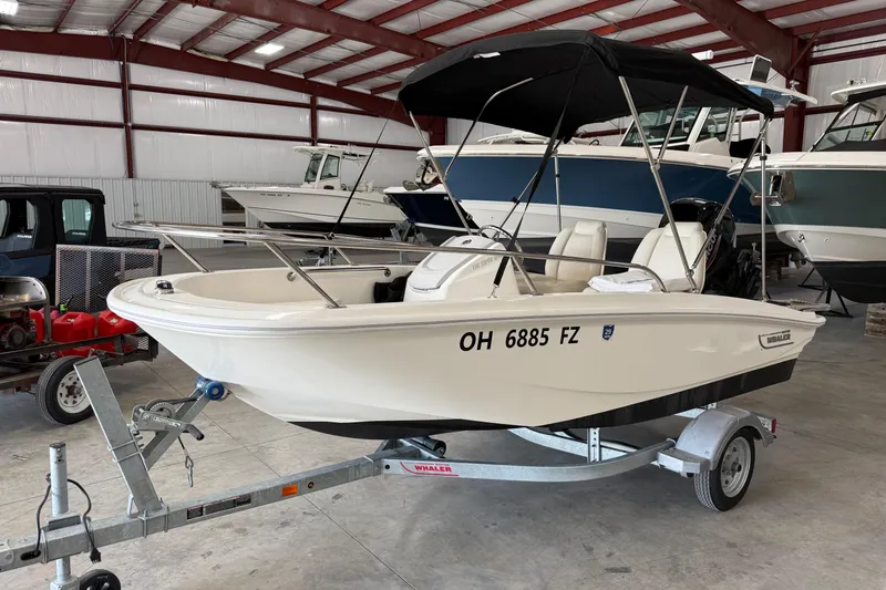 Slide: The Image of 2021 Boston Whaler 130 Super Sport boat on trailer in indoor storage facility. - 3