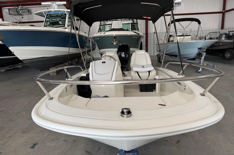 Slide: The Image of 2021 Boston Whaler 130 Super Sport boat in showroom, featuring sleek design and modern amenities. - 5