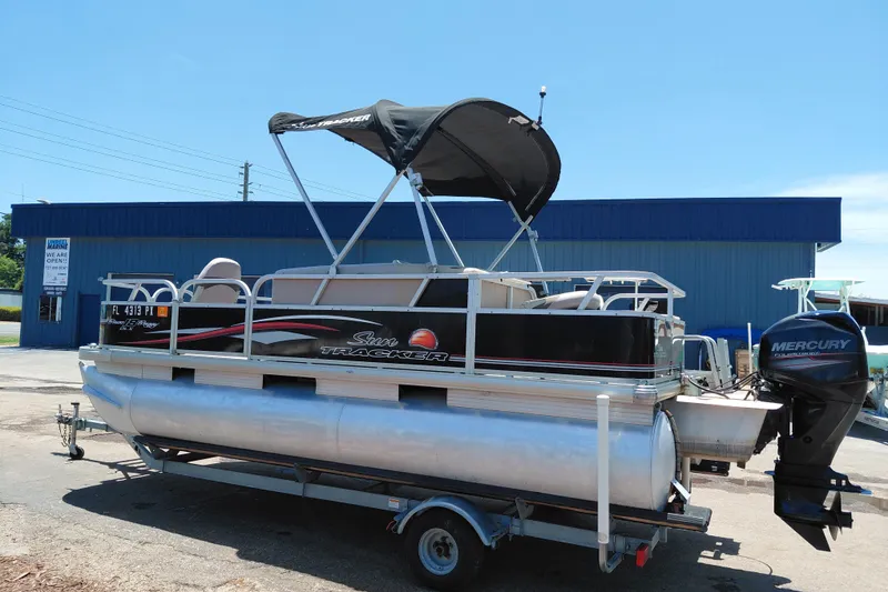 Slide: The Image of 2015 Sun Tracker Bass Buggy 18 DLX pontoon boat with Mercury outboard motor on trailer. - 6