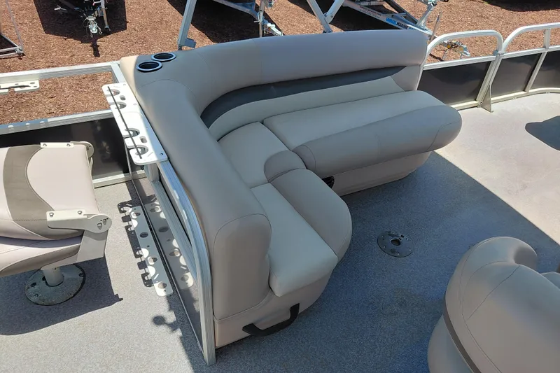 Slide: The Image of 2015 Sun Tracker Bass Buggy 18 DLX pontoon boat interior with beige seating. - 18