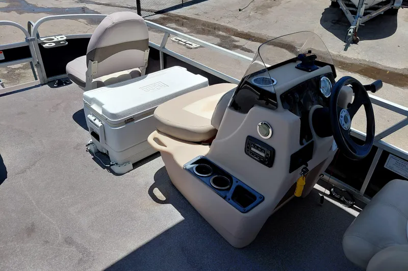 Slide: The Image of 2015 Sun Tracker Bass Buggy 18 DLX interior with steering console and seating. - 16