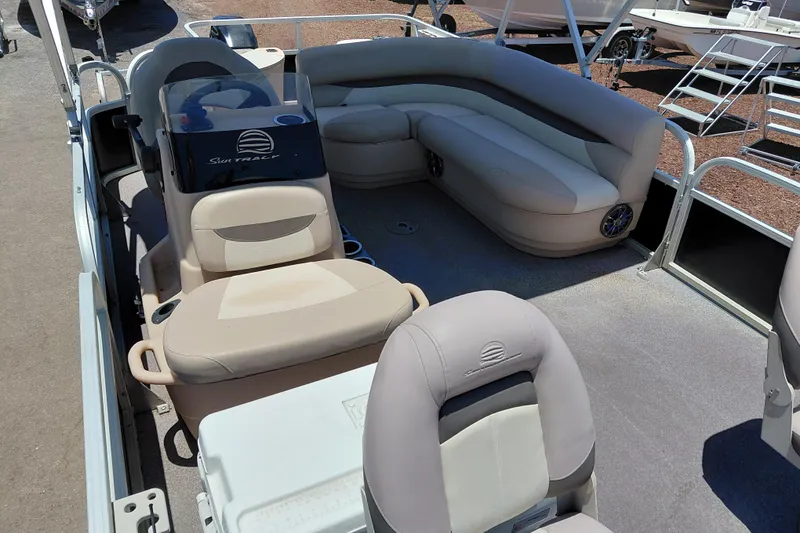 Slide: The Image of 2015 Sun Tracker Bass Buggy 18 DLX pontoon boat interior with seating and steering console. - 10