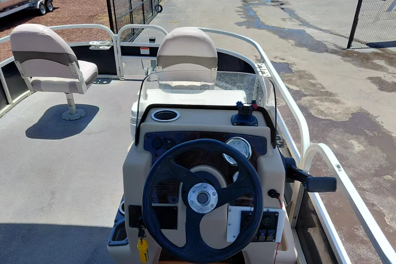 Slide: The Image of 2015 Sun Tracker Bass Buggy 18 DLX pontoon boat interior with steering console and seating. - 17