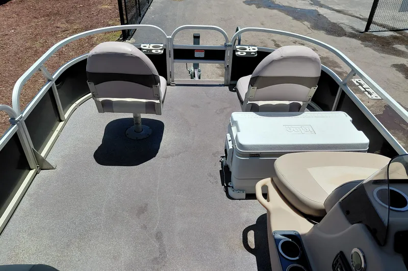 Slide: The Image of 2015 Sun Tracker Bass Buggy 18 DLX pontoon boat interior with seating and cooler. - 15