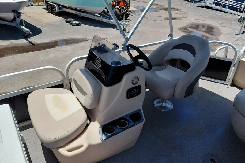 Slide: The Image of 2015 Sun Tracker Bass Buggy 18 DLX boat interior with steering console and seating. - 19