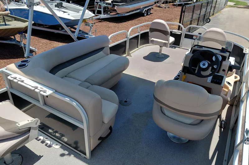 Slide: The Image of 2015 Sun Tracker Bass Buggy 18 DLX pontoon boat interior with seating and steering console. - 25