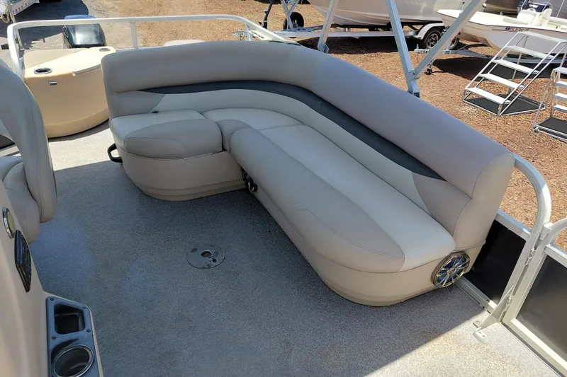 Slide: The Image of 2015 Sun Tracker Bass Buggy 18 DLX pontoon boat with beige seating and cup holders. - 14