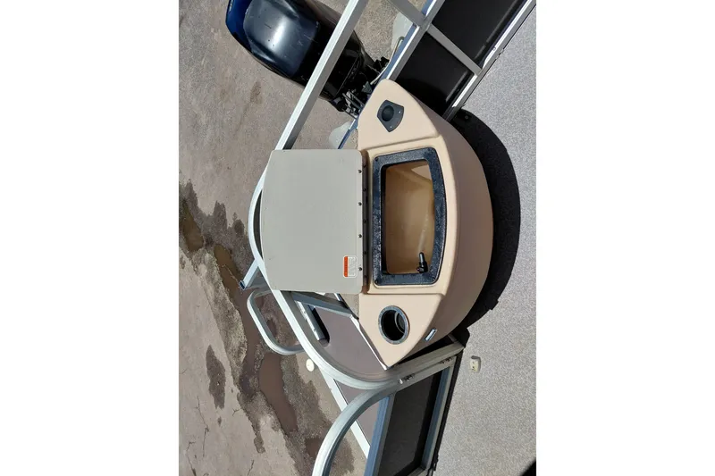 Slide: The Image of 2015 Sun Tracker Bass Buggy 18 DLX boat deck with storage compartment and motor. - 23