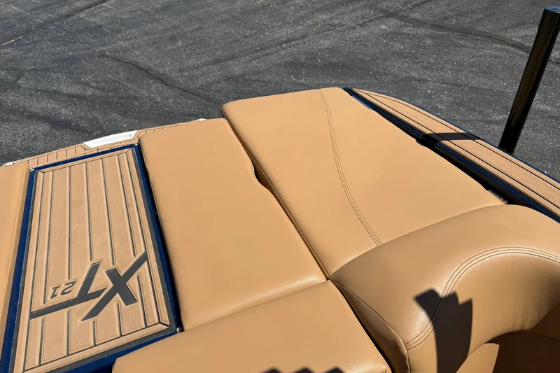 Slide: The Image of 2021 MasterCraft XT21 boat with tan upholstery and deck detail. - 19