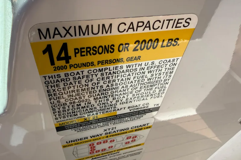 Slide: The Image of 2021 MasterCraft XT21 capacity label: 14 persons or 2000 lbs, U.S. Coast Guard compliant. - 9