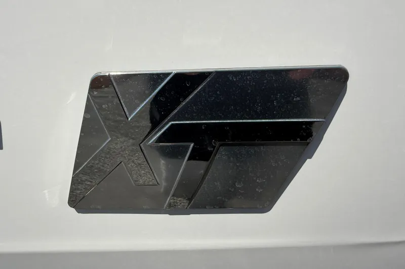 Slide: The Image of Chrome emblem of 2021 MasterCraft XT21 boat on a white surface. - 39
