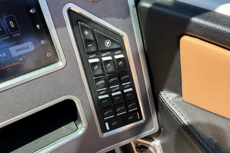 Slide: The Image of Control panel of a 2021 MasterCraft XT21 boat with various function buttons. - 42