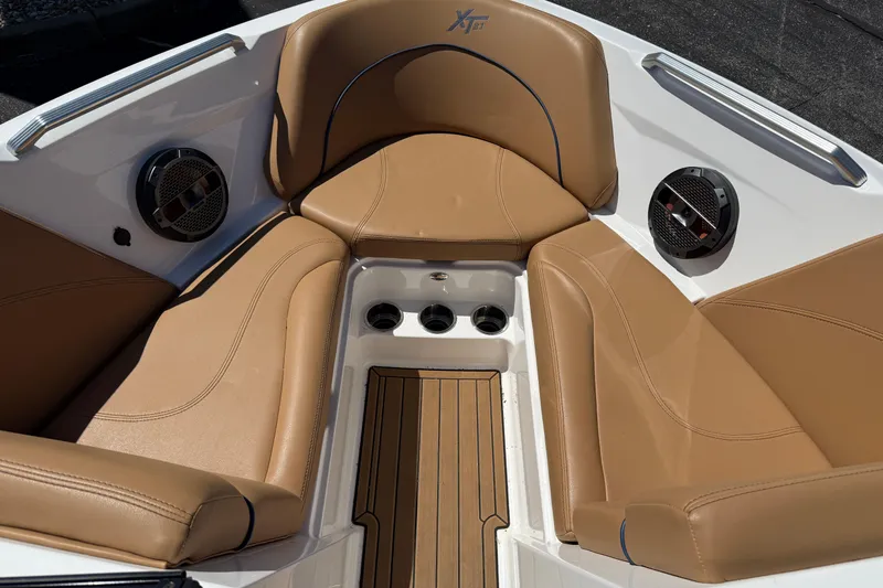 Slide: The Image of 2021 MasterCraft XT21 boat interior with tan seating and built-in speakers. - 5