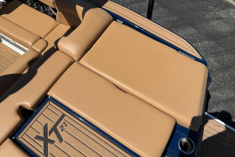 Slide: The Image of 2021 MasterCraft XT21 boat with tan leather seating and deck detail. - 29
