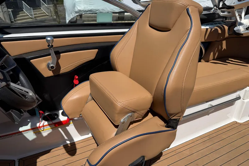 Slide: The Image of 2021 MasterCraft XT21 boat interior with tan leather seating and modern controls. - 41