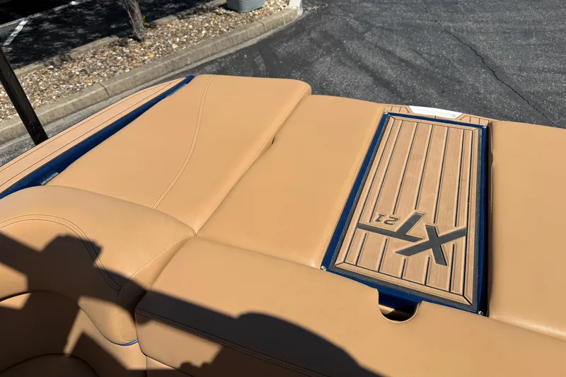 Slide: The Image of 2021 MasterCraft XT21 boat with tan upholstery and XT21 logo on deck. - 18