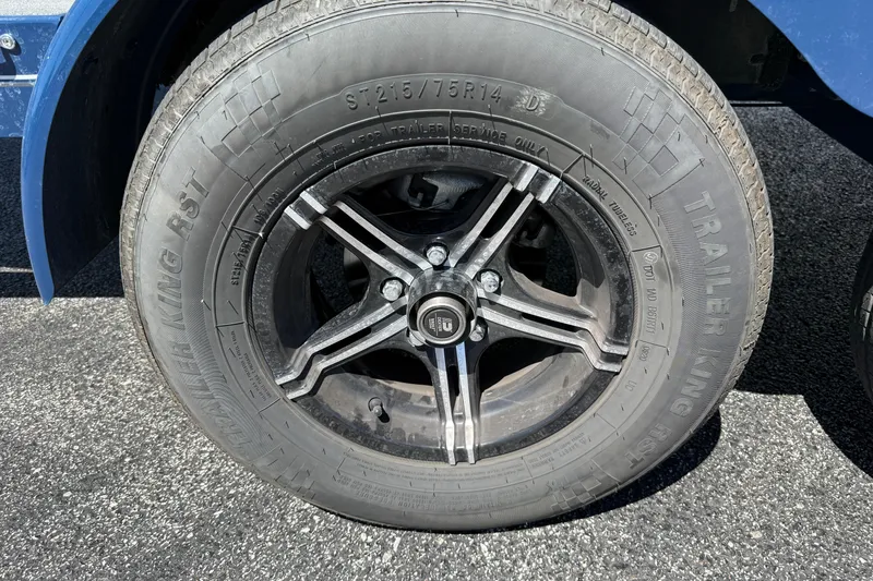 Slide: The Image of Close-up of a 2021 MasterCraft XT21 trailer tire and alloy wheel on asphalt. - 40