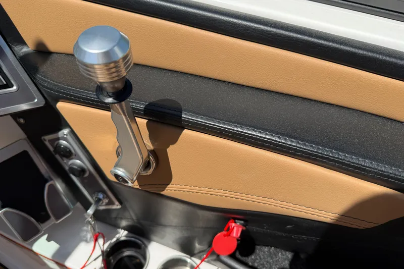 Slide: The Image of Interior detail of 2021 MasterCraft XT21 boat, featuring gear lever and cup holders. - 24
