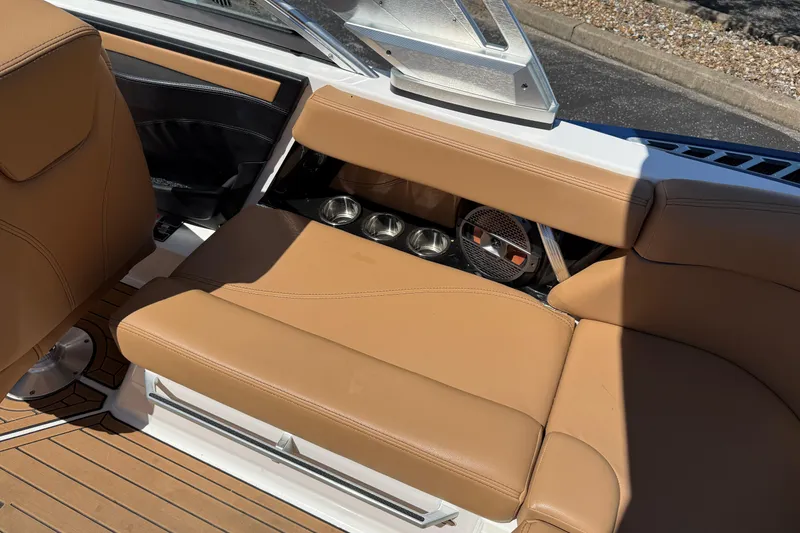 Slide: The Image of 2021 MasterCraft XT21 boat interior with tan seating and cup holders. - 17