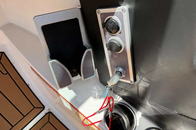 Slide: The Image of Control panel and cup holder on a 2021 MasterCraft XT21 boat. - 23