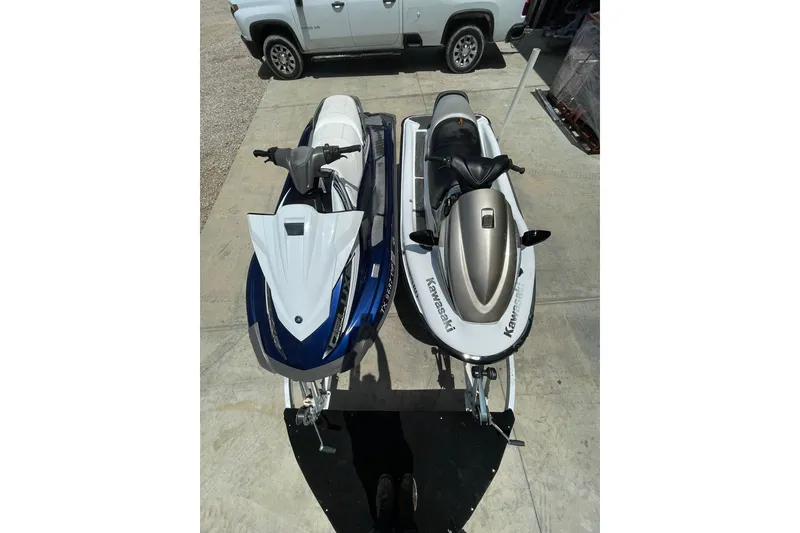 Slide: The Image of Two jet skis, Yamaha VX-Deluxe 2016 and Kawasaki, parked on a trailer. - 1