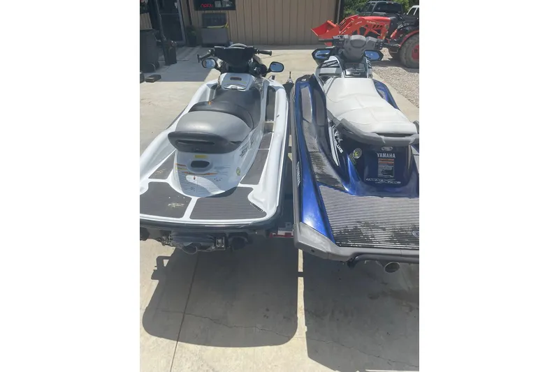 Slide: The Image of Two Yamaha VX-Deluxe jet skis, 2016 models, parked side by side outdoors. - 4