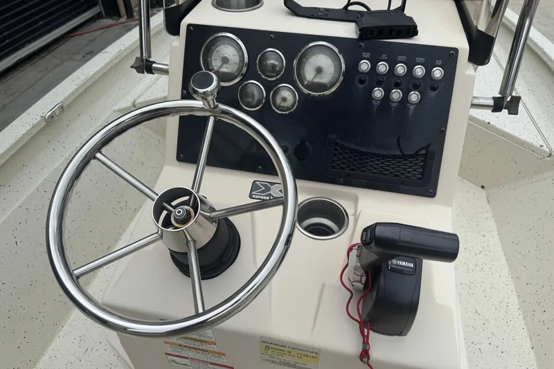 Slide: The Image of 2020 Xpress H22B Bay boat dashboard with steering wheel and Yamaha controls. - 18