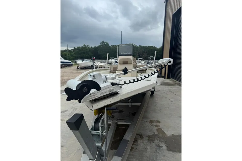 Slide: The Image of 2020 Xpress H22B Bay boat on trailer, parked outdoors under cloudy sky. - 8