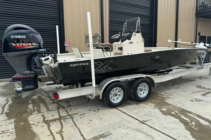 Slide: The Image of 2020 Xpress H22B Bay boat on trailer with Yamaha VMAX outboard motor. - 22
