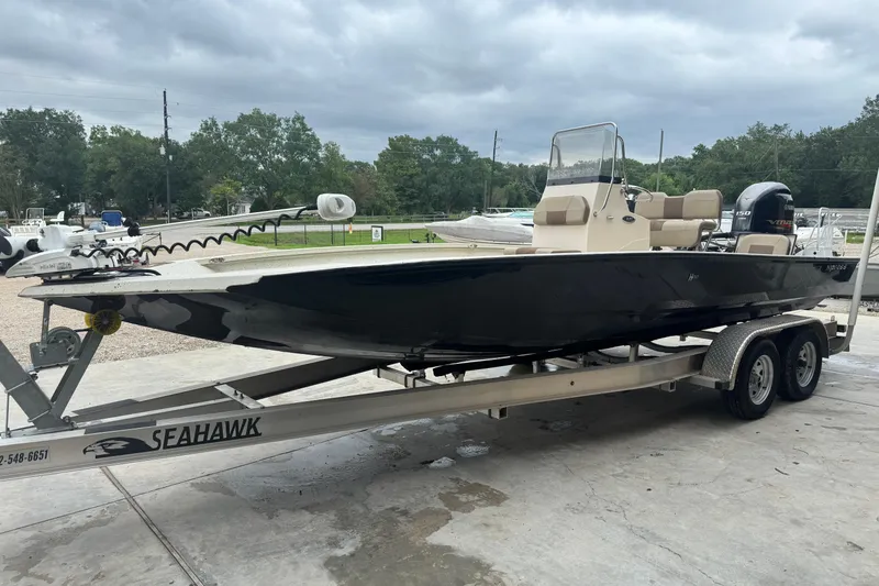 Slide: The Image of 2020 Xpress H22B Bay boat on Seahawk trailer, parked outdoors. - 7