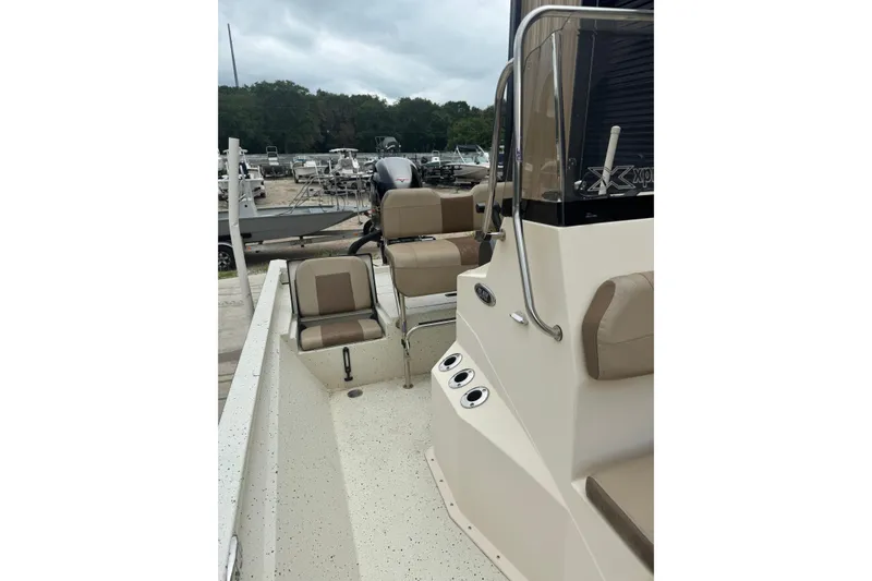 Slide: The Image of 2020 Xpress H22B Bay boat interior with seating and console, docked at marina. - 14