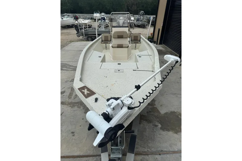 Slide: The Image of 2020 Xpress H22B Bay boat with trolling motor, parked outdoors. - 5