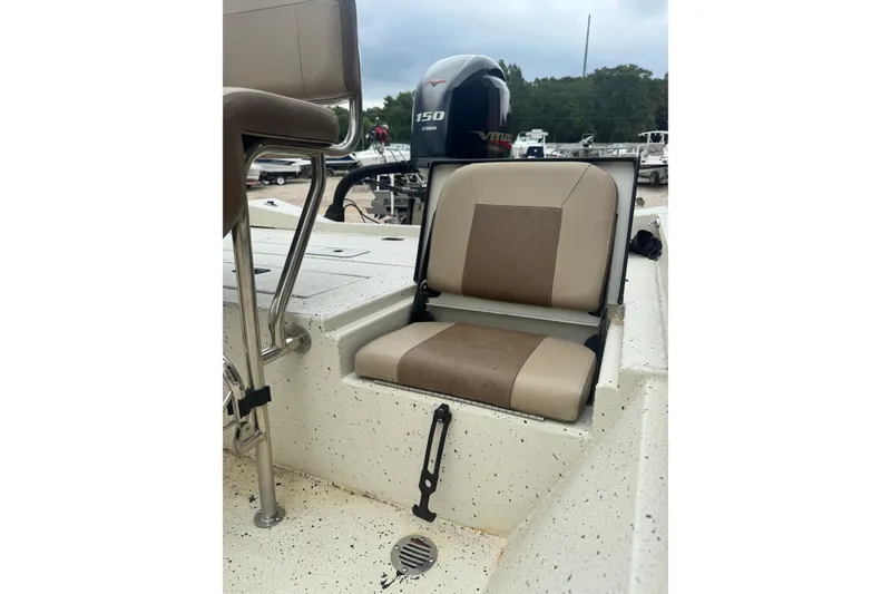 Slide: The Image of 2020 Xpress H22B Bay boat with beige seating and Yamaha 150 engine. - 20