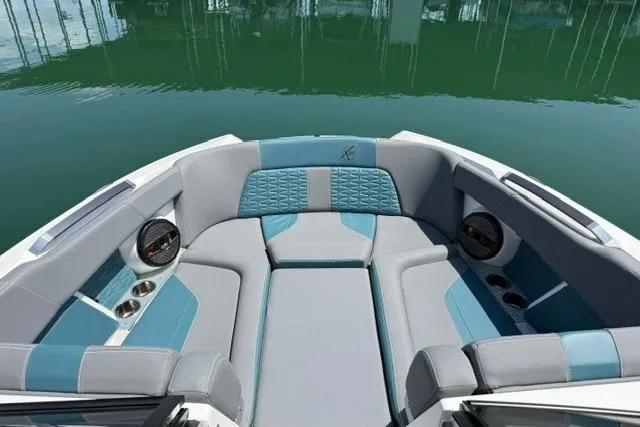 Slide: The Image of 2025 MasterCraft X24 boat interior with luxurious seating and modern design on calm water. - 7
