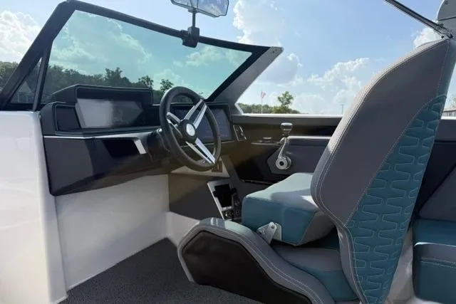 Slide: The Image of Interior of 2025 MasterCraft X24 boat, featuring modern steering and seating design. - 12