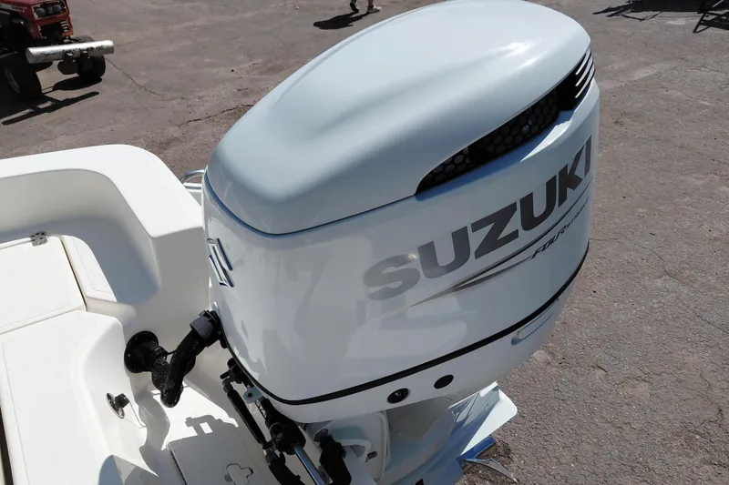 Slide: The Image of 2023 Pioneer 220 Bay Sport with Suzuki outboard motor, parked on pavement. - 50