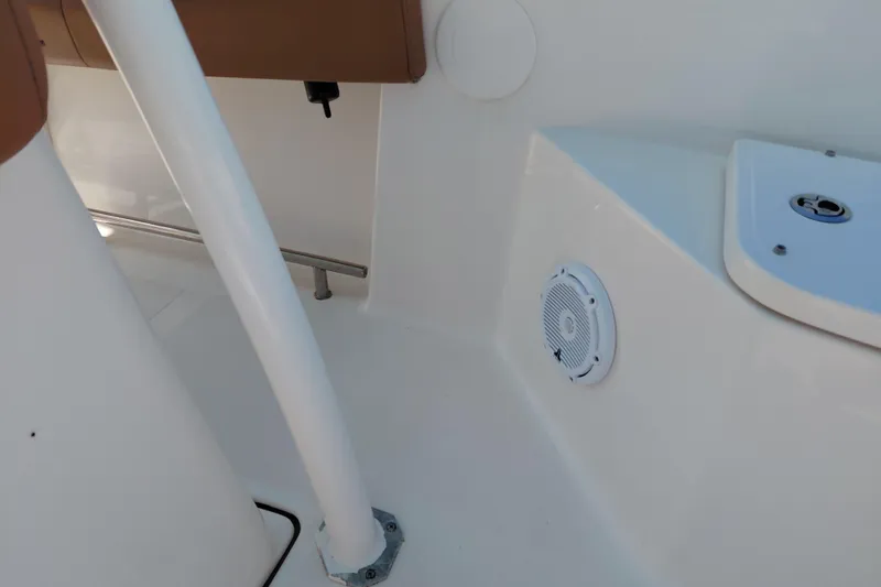 Slide: The Image of Interior view of 2023 Pioneer 220 Bay Sport boat, featuring seating and speaker. - 25
