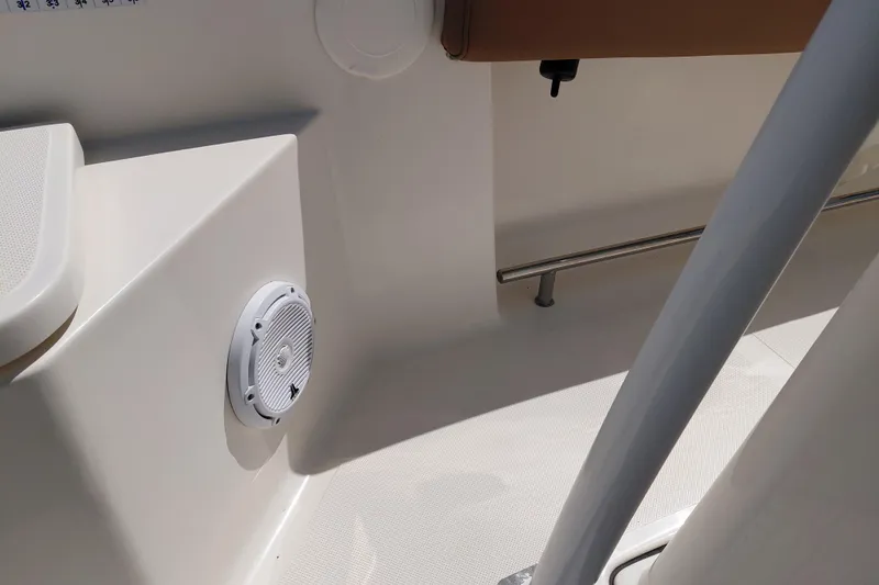 Slide: The Image of Interior view of 2023 Pioneer 220 Bay Sport boat, featuring a speaker and seating area. - 26