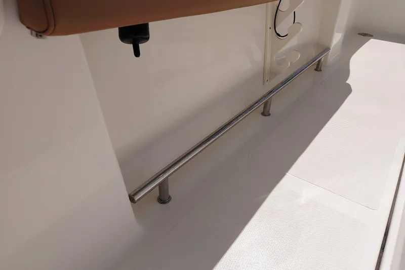 Slide: The Image of 2023 Pioneer 220 Bay Sport boat interior with stainless steel railing and white deck. - 32