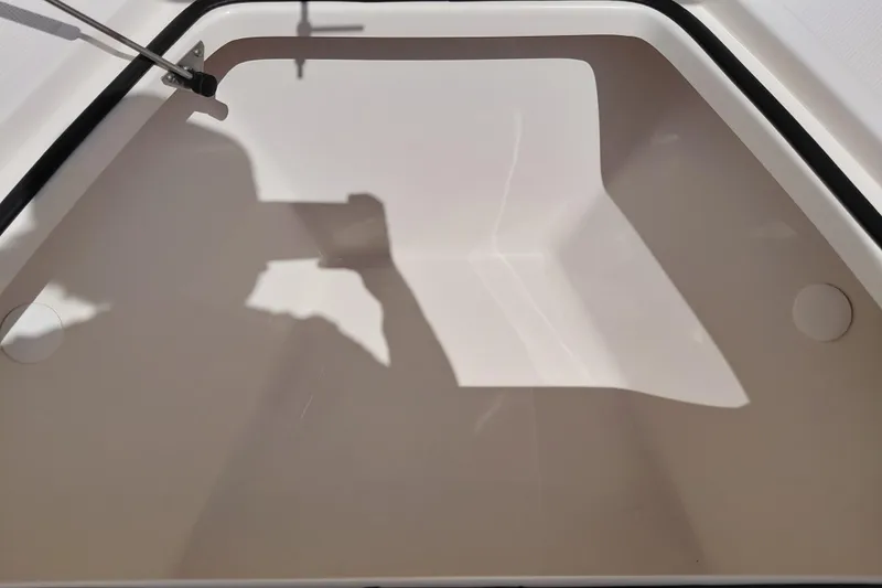 Slide: The Image of Interior view of 2023 Pioneer 220 Bay Sport boat compartment with shadow reflection. - 12