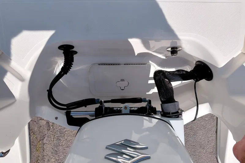 Slide: The Image of 2023 Pioneer 220 Bay Sport boat engine compartment with cables and connections visible. - 48