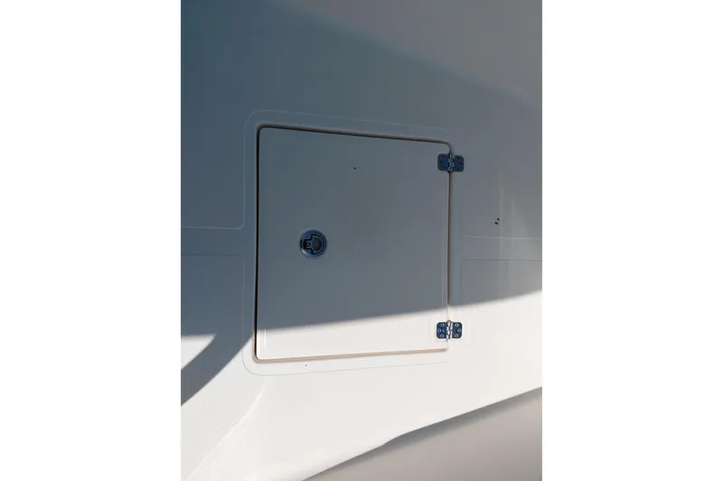 Slide: The Image of Hatch door on 2023 Pioneer 220 Bay Sport boat, featuring secure hinges and latch. - 19