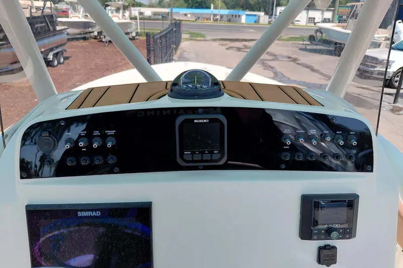Slide: The Image of 2023 Pioneer 220 Bay Sport boat dashboard with navigation and control panels. - 37