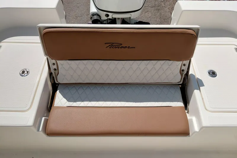 Slide: The Image of 2023 Pioneer 220 Bay Sport boat seat with brown and white upholstery. - 41