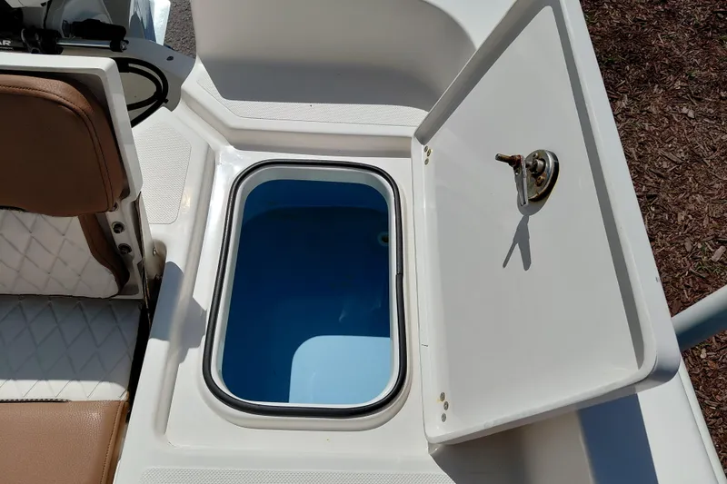 Slide: The Image of Open storage compartment on 2023 Pioneer 220 Bay Sport boat, featuring cushioned seating. - 43